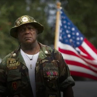 Saluting Veteran and American Flag on Veterans Day